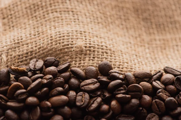 Close up view of fresh roasted coffee beans in sack — Stock Photo