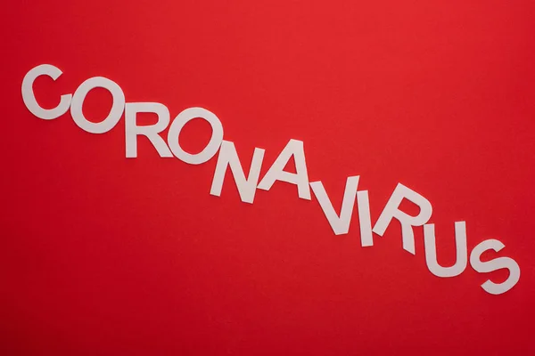 Top view of coronavirus lettering isolated on red — Stock Photo