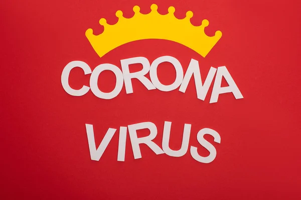 Top view of coronavirus lettering with crown isolated on red — Stock Photo