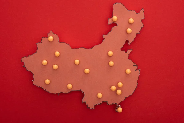 Top view of map of china with yellow push pins on red background — Stock Photo