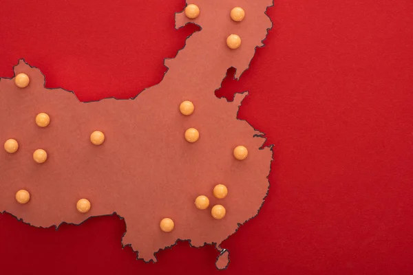 Top view of map of china with yellow push pins on red background — Stock Photo