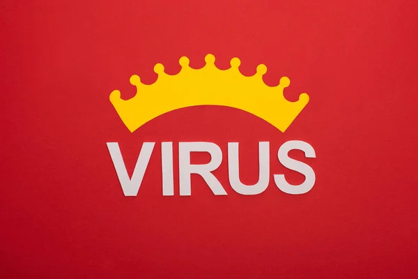 Top view of crown and virus lettering isolated on red — Stock Photo