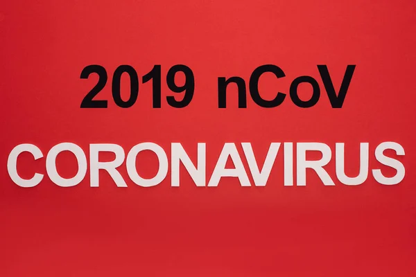 Top view of 2019 ncov and coronavirus lettering isolated on red — Stock Photo