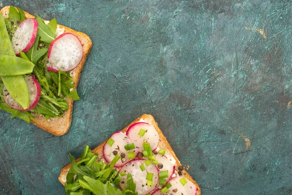 Top view of organic radish sandwiches on green stone table — Stock Photo