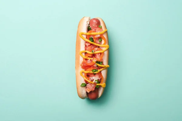 Top view of one tasty hot dog on blue — Stock Photo