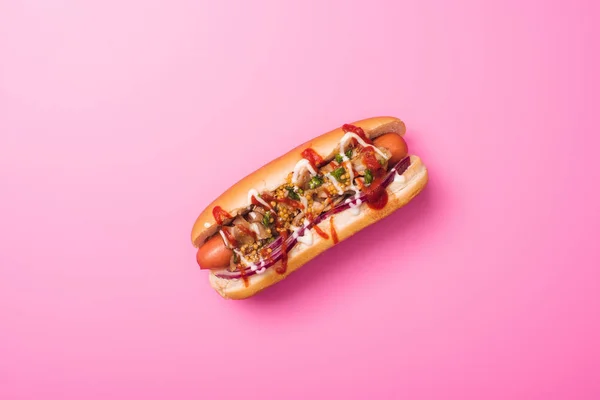 Top view of one tasty hot dog on pink — Stock Photo