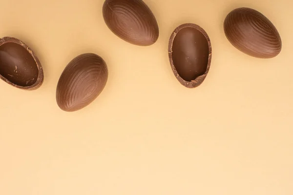 Top view of chocolate eggs on beige background — Stock Photo