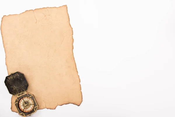 Top view of vintage compass on aged paper isolated on white — Stock Photo