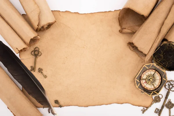 Top view of retro keys, feather and compass on aged paper isolated on white — Stock Photo