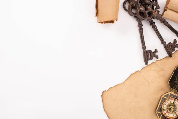 Top view of retro keys, compass on aged paper isolated on white — Stock Photo