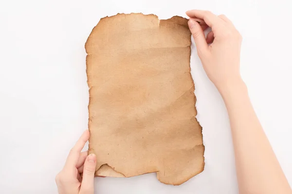 Cropped view of woman holding empty aged paper isolated on white — Stock Photo