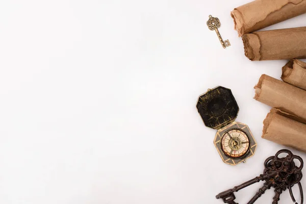 Top view of vintage compass, keys and aged parchment paper isolated on white — Stock Photo