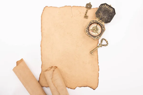 Top view of vintage compass, keys and aged parchment paper isolated on white — Stock Photo