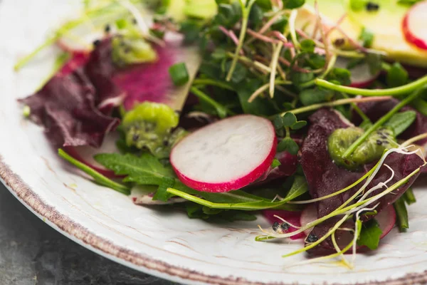 Close up view of fresh radish salad with greens — Stock Photo
