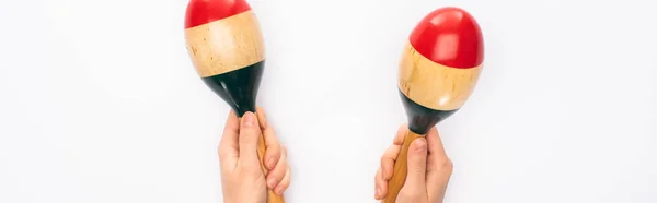 Cropped view of woman holding maracas on white background, panoramic shot — Stock Photo