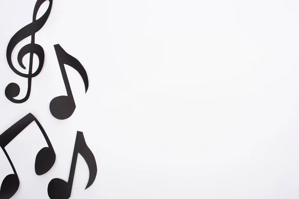Top view of paper cut music notes on white background — Stock Photo