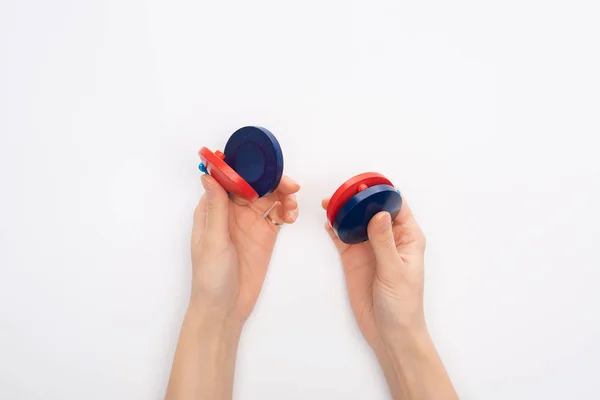 Cropped view of woman holding castanets on white background — Stock Photo