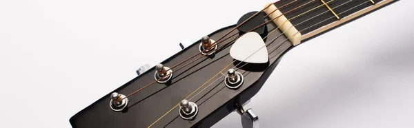 Close-up vista de picaretas de guitarra sob cordas no fundo branco, tiro panorâmico — Fotografia de Stock