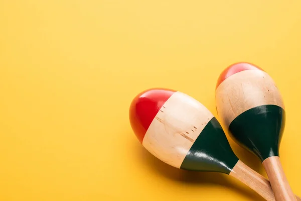 Close up view of wooden maracas on yellow background — Stock Photo