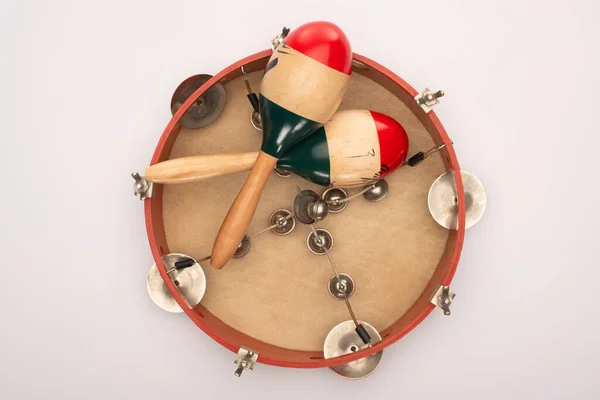 Top view of wooden maracas on tambourine on white background — Stock Photo