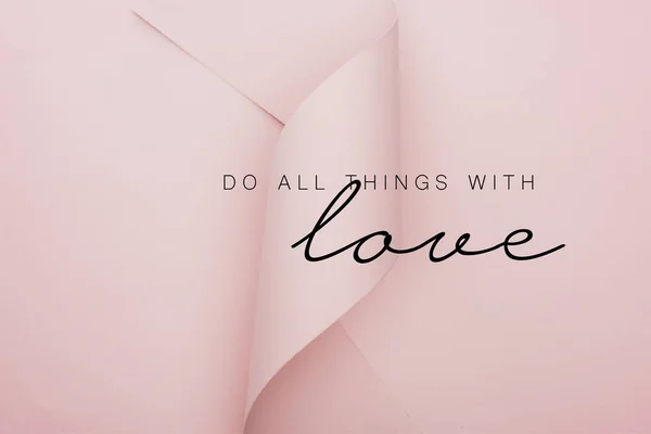 Top view of pink paper swirl on pink background, do all thing with love illustration — Stock Photo