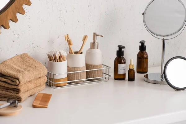 Round mirrors with cosmetic and hygiene products in bathroom, zero waste concept — Stock Photo