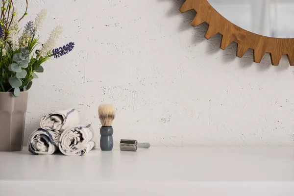 Flowerpot, towels, shaving brush and razor near mirror on wall in bathroom, zero waste concept — Stock Photo