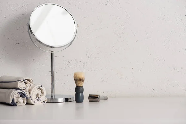 Towels, round mirror, shaving brush and razor on white background, zero waste concept — Stock Photo