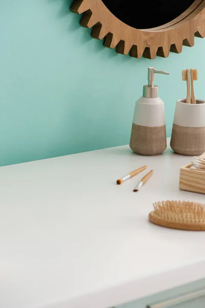 Hygiene and beauty objects near round mirror in bathroom, zero waste concept — Stock Photo