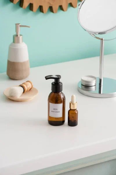 Selective focus of eco body cream and cosmetic oil and hygiene objects in bathroom, zero waste concept — Stock Photo