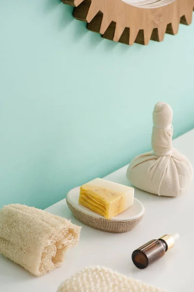 Selective focus of loofah, bottle of cosmetic oil, soap and thai herbal compress ball in bathroom, zero waste concept — Stock Photo