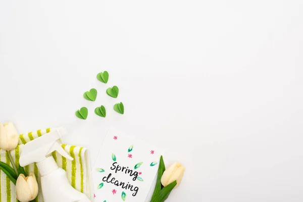 Vista dall'alto dei tulipani primaverili e dei prodotti per la pulizia verdi vicino alla carta di pulizia primaverile su sfondo bianco — Foto stock