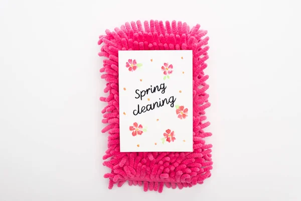 Top view of pink sponge and spring cleaning card on white background — Stock Photo