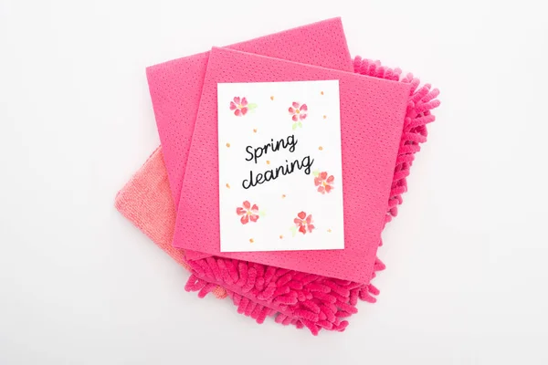 Top view of pink cleaning supplies and spring cleaning card on white background — Stock Photo