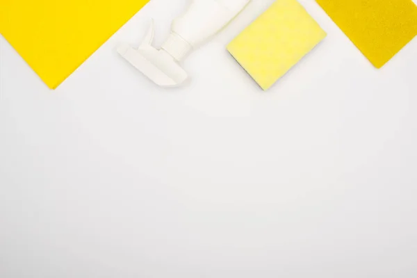 Top view of yellow cleaning supplies on white background — Stock Photo