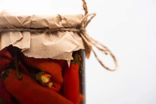 Close up view of homemade tasty canned chili peppers in jar isolated on white — Stock Photo