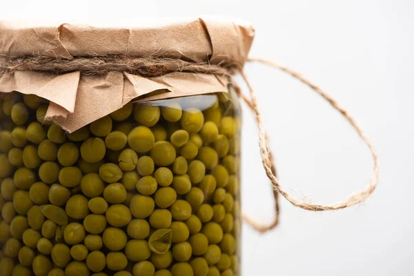 Close up view of homemade tasty canned green peas in jar isolated on white — Stock Photo