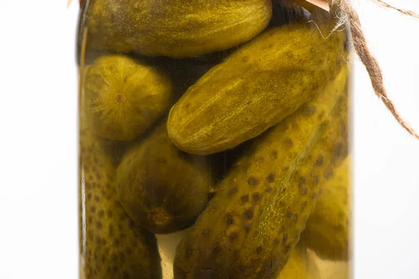 Close up view of homemade tasty canned cucumbers in jar isolated on white — Stock Photo