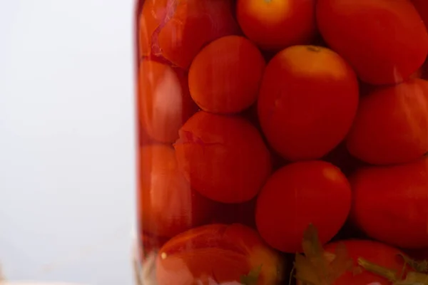 Close up view of homemade delicious pickled tomatoes in jar isolated on grey — Stock Photo