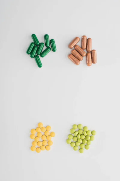 Вид зверху таблеток і капсул на білому тлі — стокове фото