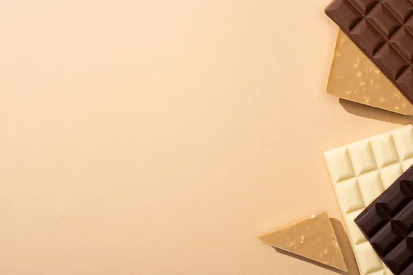 Top view of delicious chocolate bars isolated on beige — Stock Photo