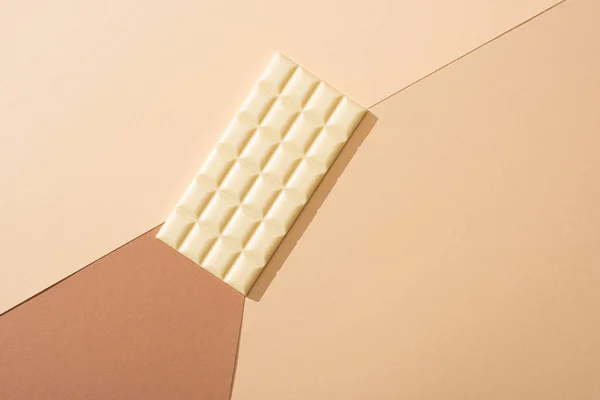 Top view of delicious whole white chocolate bar on beige background — Stock Photo