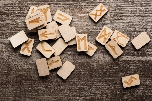 Vista superior de runas chamánicas con símbolos sobre fondo de madera - foto de stock