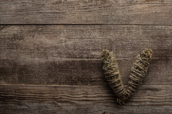 Top view of herbal smudge sticks on wooden background — Stock Photo