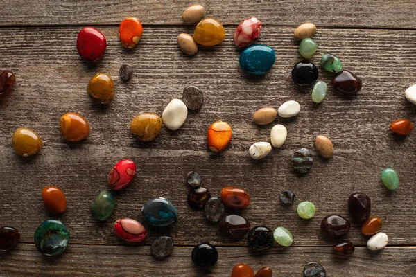 Top view of colorful fortune telling stones on wooden surface — Stock Photo