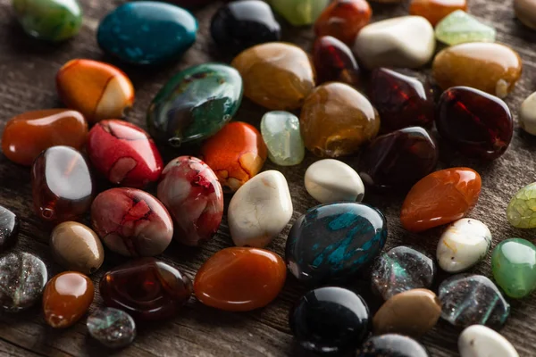 Colorful fortune telling stones on wooden background — Stock Photo