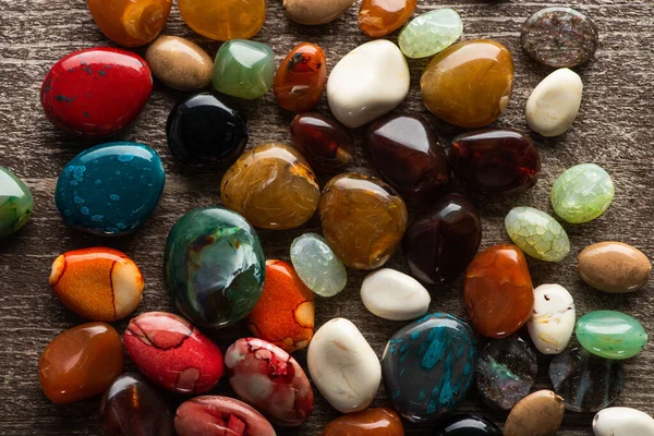 Top view of colorful fortune telling stones on wooden background — Stock Photo