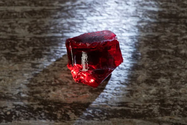 Top view of magical red crystal with light on wooden background — Stock Photo