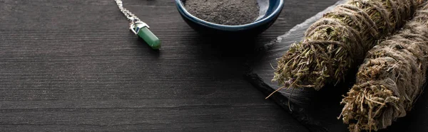 Close up view of smudge sticks, bowl with ash and magic crystal on dark wooden background — Stock Photo