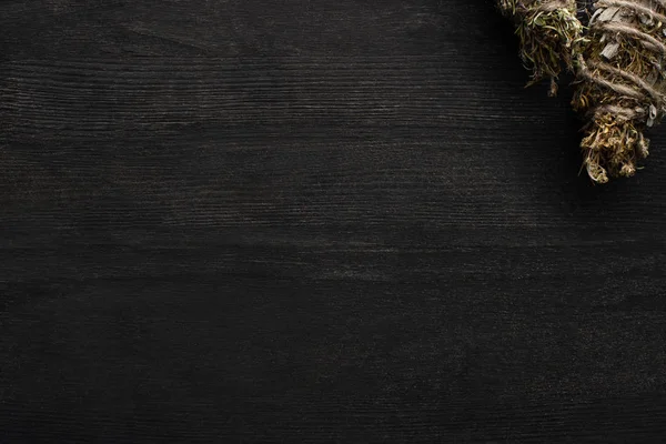 Top view of shamanic smudge sticks on dark wooden background — Stock Photo